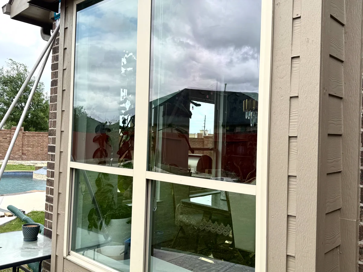 A cleaned exterior window reflecting a clear sky.