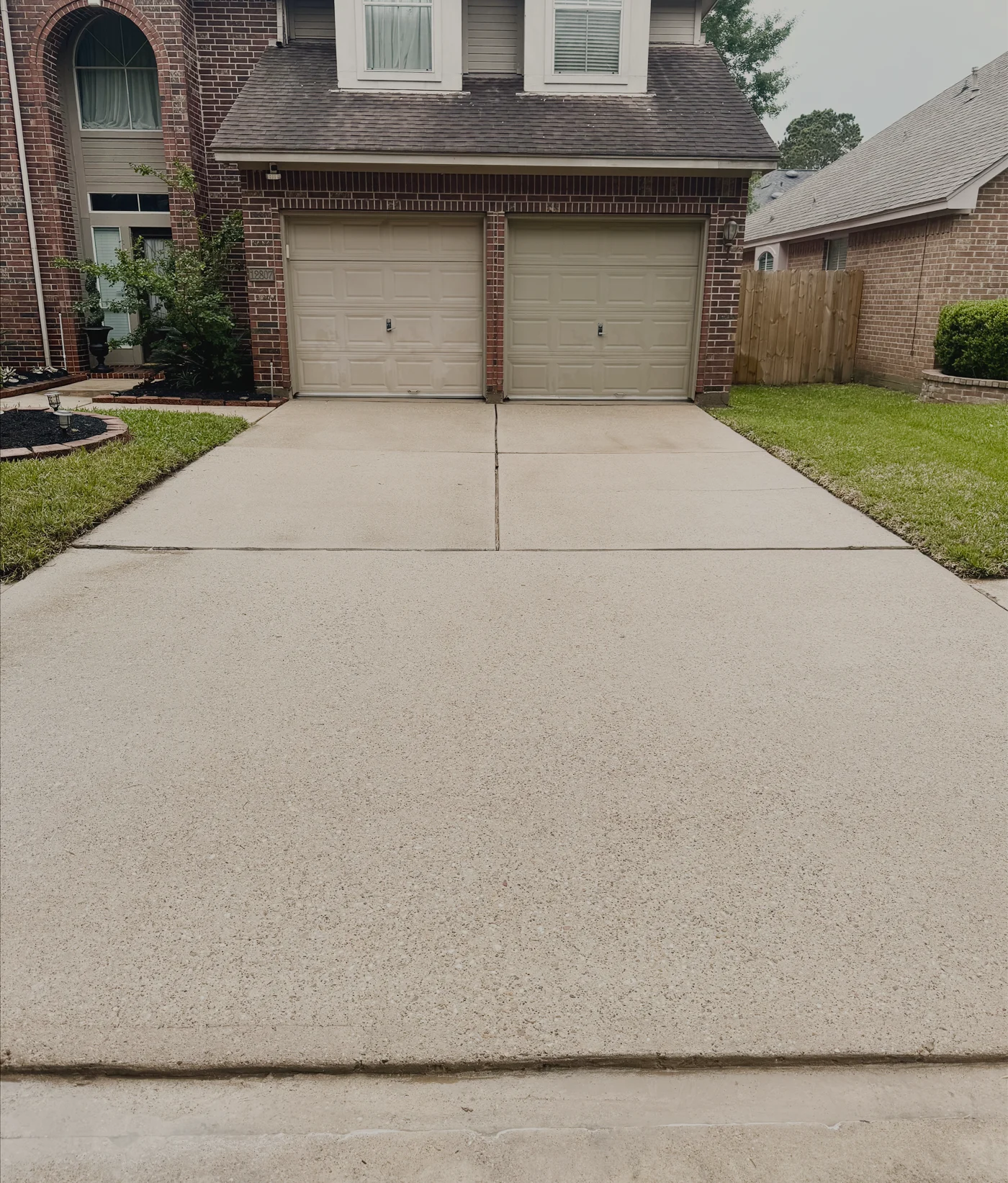 The same brick-home driveway after washing — bright and spotless